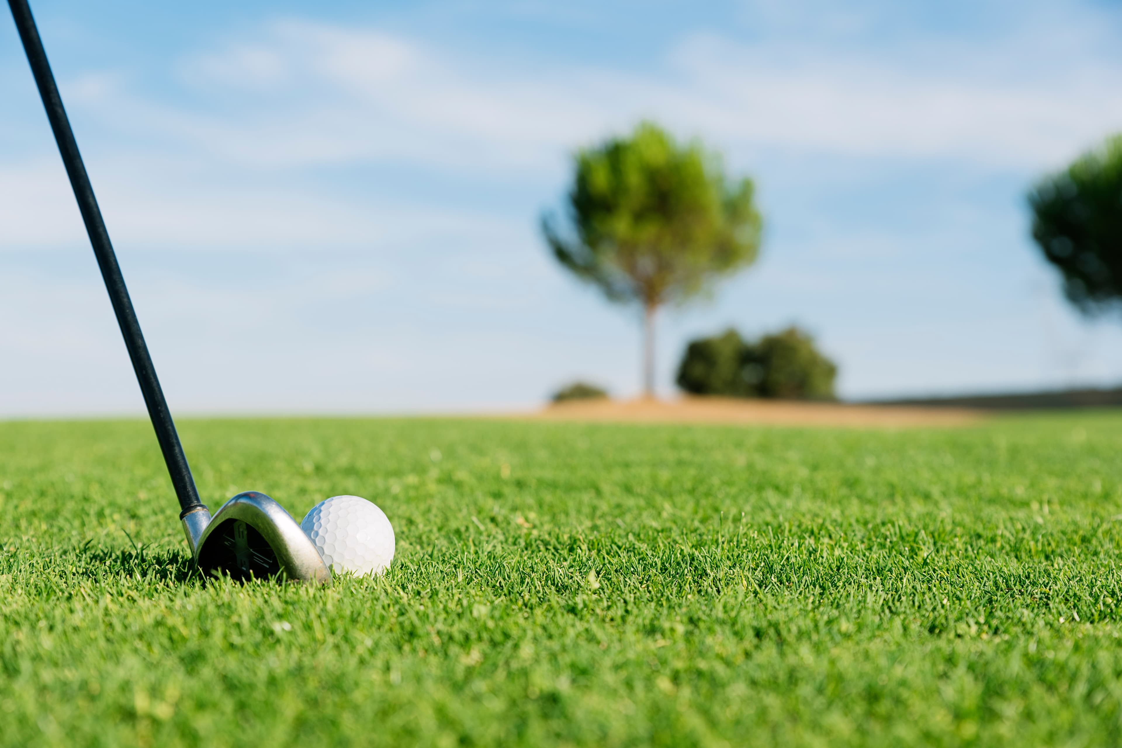 Golfer swinging on a beautiful golf course